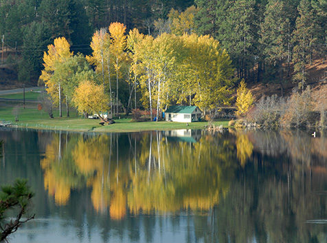 Cabin and trees with autumn foliage at Curlew Lake, WA