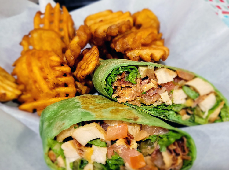 Buckhorn wrap: Chicken, bacon, grilled onions, tomatoes, cheddar cheese and their Signature Buckhorn BBQ sauce.